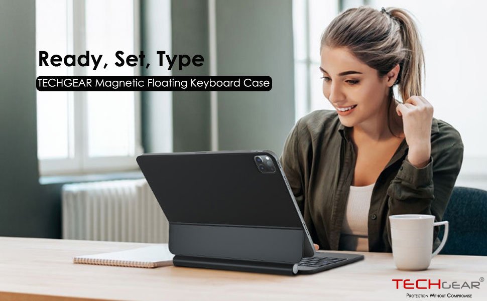 TECHGEAR magnetic floating keyboard case for tablet, shown in use by a woman at a desk with a coffee cup.